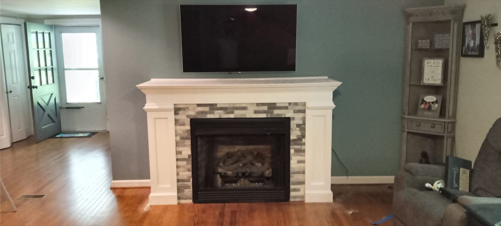 White custom fireplace surround with mantel and side shelving