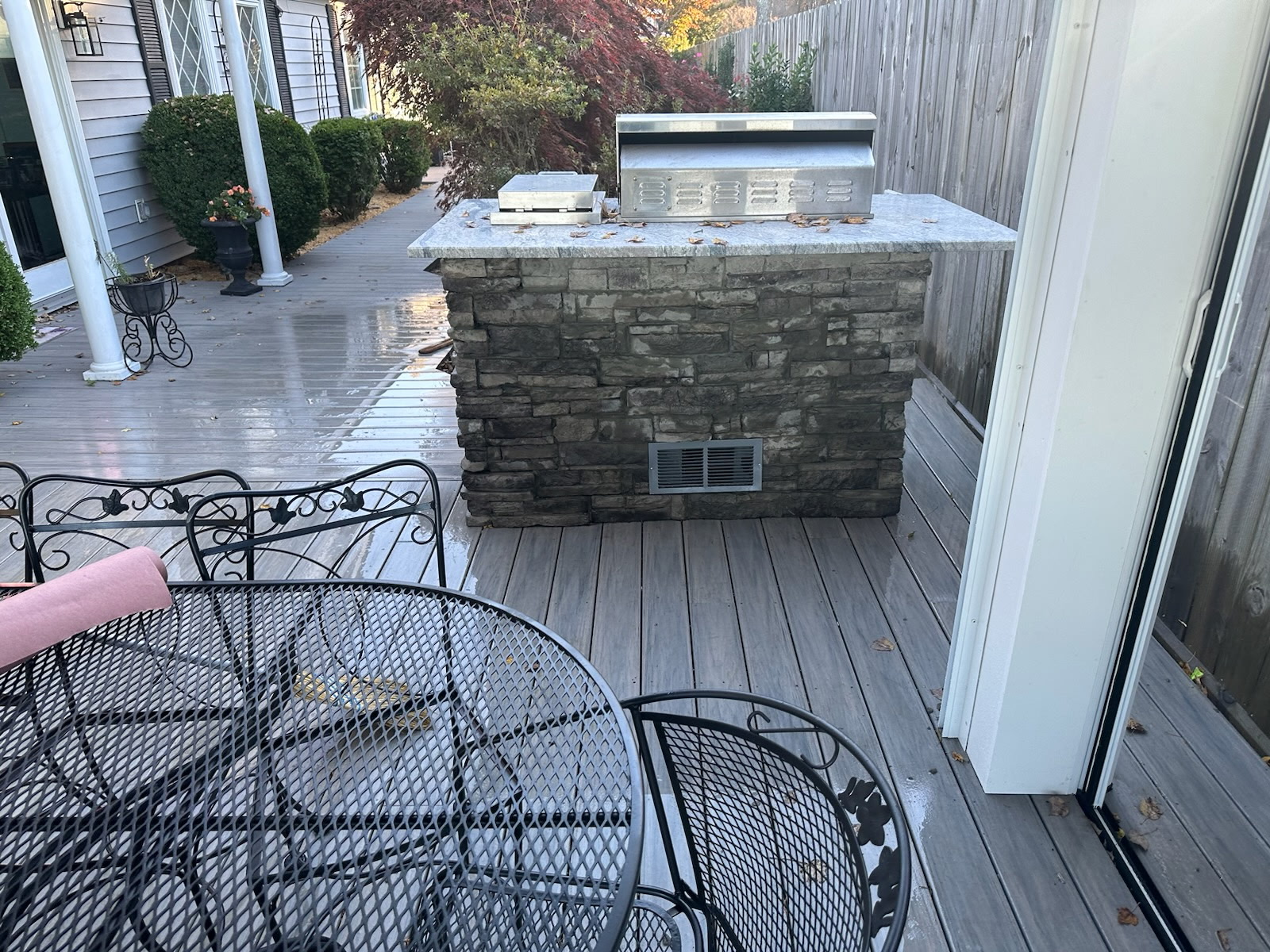 Stone outdoor kitchen and grill built into a composite deck