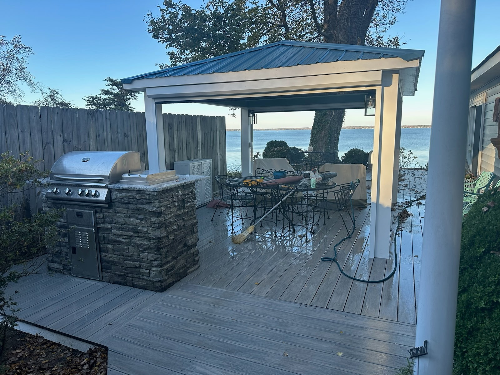 White waterfront gazebo on a finished composite deck