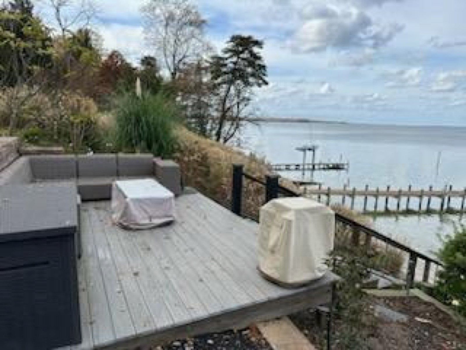 Composite waterfront terrace with seating and a wide water view