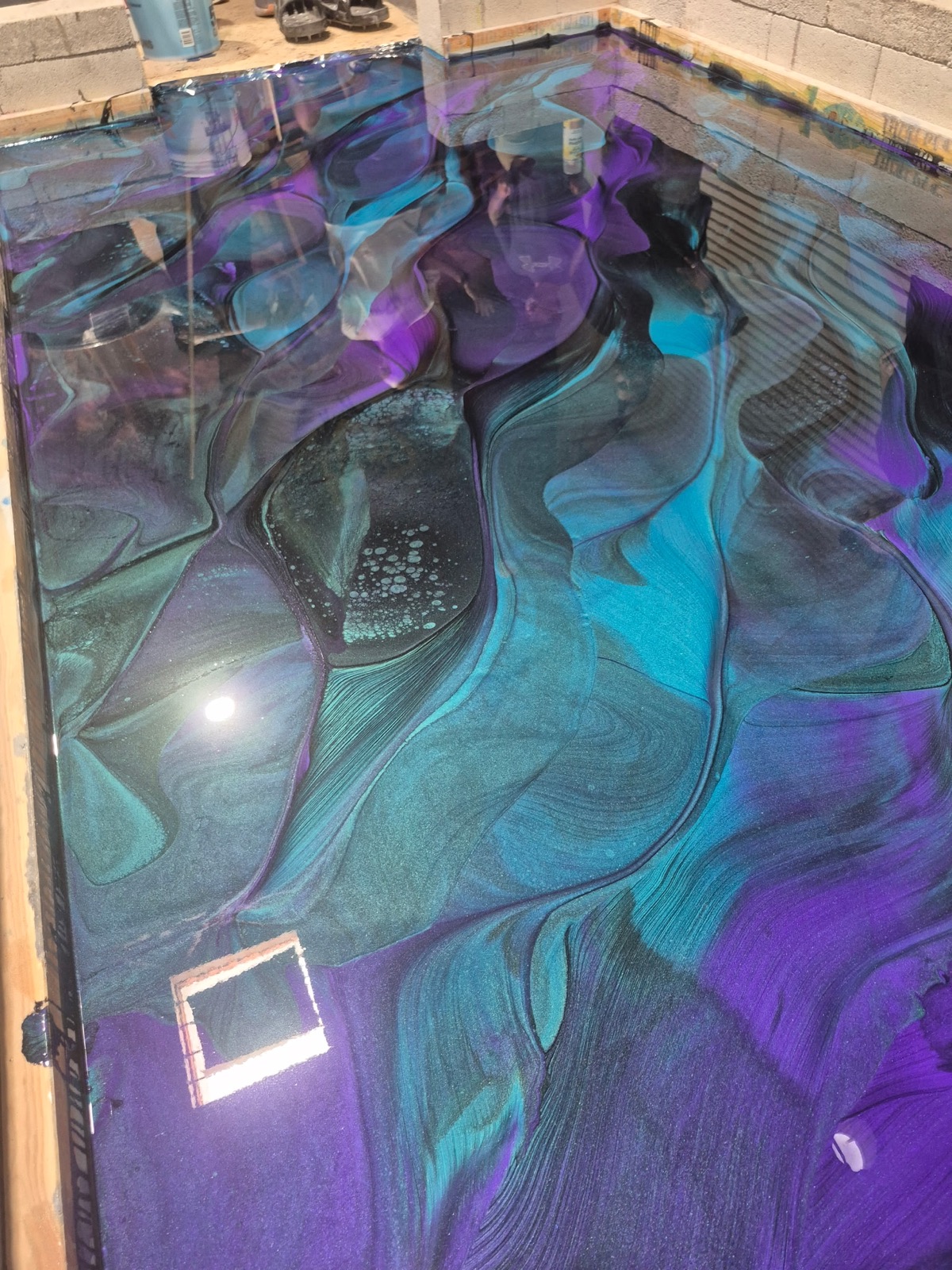 Close view of a blue, violet, and teal resin surface