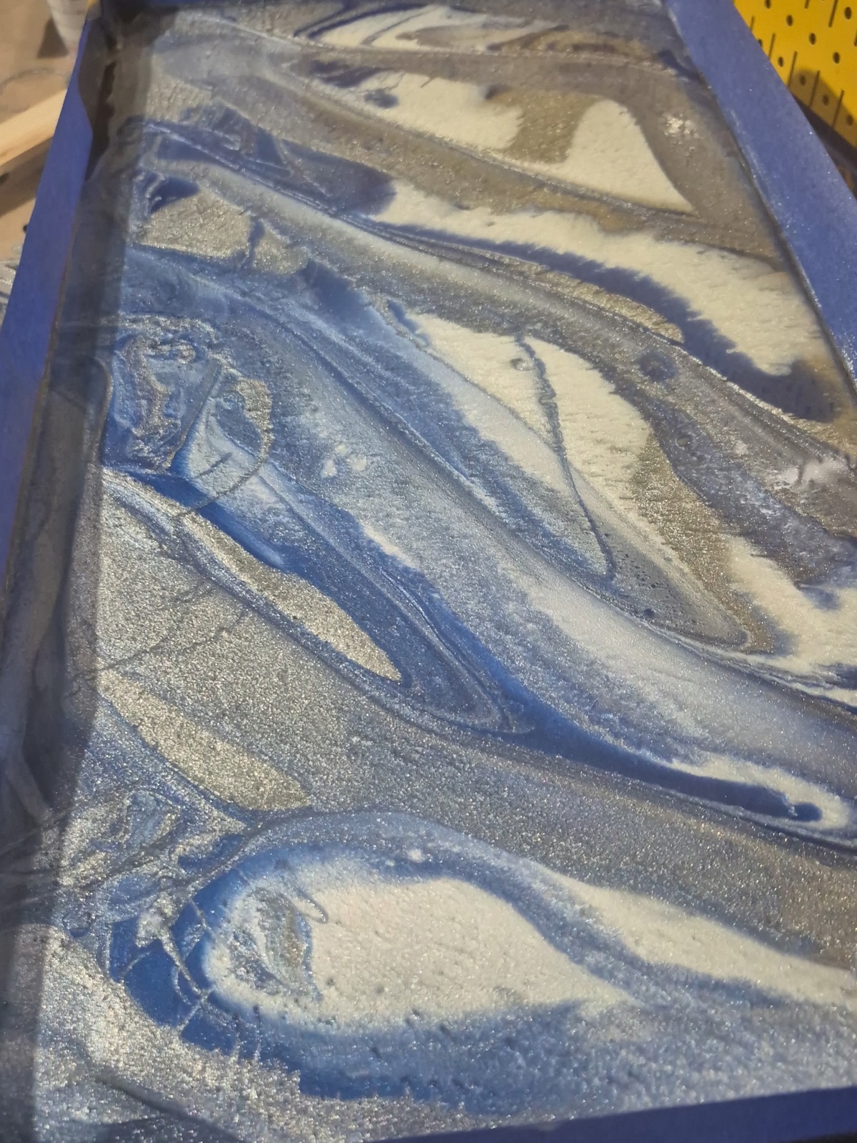 Silver and electric-blue marbled resin surface